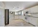 Bright kitchen features white cabinets, stainless steel appliances, and modern track lighting at 8333 Valley Stream Ave, Las Vegas, NV 89131