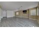 Open-concept living room with hardwood floors and a mounted TV with neutral paint and trim at 8333 Valley Stream Ave, Las Vegas, NV 89131