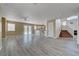 Open-concept living room with an easy transition to kitchen, access to the backyard, and carpeted stairs at 8333 Valley Stream Ave, Las Vegas, NV 89131