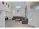 Spacious living room with high ceilings, many windows and vinyl flooring leading into the dining area at 8333 Valley Stream Ave, Las Vegas, NV 89131