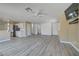 Open concept living area with hardwood-style floors and a kitchen with stainless steel appliances at 8333 Valley Stream Ave, Las Vegas, NV 89131