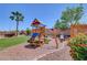 Backyard featuring a wooden play structure with a slide and swings for outdoor fun at 8333 Valley Stream Ave, Las Vegas, NV 89131
