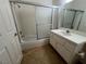 Clean bathroom with a shower-tub combo, bright vanity, and tile flooring offering functional elegance at 8940 Antioch Way, Las Vegas, NV 89117