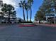 Well-maintained community entrance with palm trees and manicured landscaping at 8940 Antioch Way, Las Vegas, NV 89117