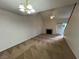 Spacious living room featuring a fireplace, ceiling fan, and sliding glass door to the outside at 8940 Antioch Way, Las Vegas, NV 89117