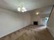 Open living room with ceiling fan, fireplace, and large windows for ample natural light at 8940 Antioch Way, Las Vegas, NV 89117
