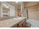 Well-lit bathroom with a granite countertop, tiled shower, and vanity at 9270 Valerie Elaine St, Las Vegas, NV 89139