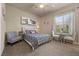 Cozy bedroom with a comfortable bed, side chair, and natural light at 9270 Valerie Elaine St, Las Vegas, NV 89139