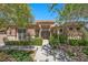 Charming single-story home boasts a stone facade, lush landscaping, and welcoming walkway at 9270 Valerie Elaine St, Las Vegas, NV 89139