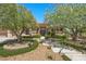 Landscaped front yard with stone and stucco single-story home with trees flanking lighted stone and concrete walkway at 9270 Valerie Elaine St, Las Vegas, NV 89139