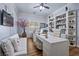 Bright home office with custom built-ins, two desks, and comfortable seating at 9270 Valerie Elaine St, Las Vegas, NV 89139