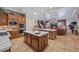 Bright kitchen with a center island, wooden cabinets, and seamless flow to the living space at 9270 Valerie Elaine St, Las Vegas, NV 89139