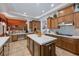Open kitchen featuring a central island, custom cabinetry, and modern countertops at 9270 Valerie Elaine St, Las Vegas, NV 89139