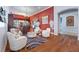 Elegant living room featuring hardwood floors, seating, and a bar area, bathed in natural light at 9270 Valerie Elaine St, Las Vegas, NV 89139
