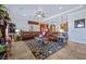 Open-concept living room flows into kitchen with seating area, ceiling fan, recessed lighting, and tile floors at 9270 Valerie Elaine St, Las Vegas, NV 89139