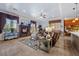 Bright living room features a fireplace, large windows with custom drapes, and a ceiling fan at 9270 Valerie Elaine St, Las Vegas, NV 89139