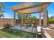 Charming covered patio with cozy seating area and pergola, great for relaxing outdoors at 9270 Valerie Elaine St, Las Vegas, NV 89139