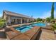 Lush backyard featuring a refreshing pool, spa, and comfortable seating area for outdoor relaxation at 9270 Valerie Elaine St, Las Vegas, NV 89139