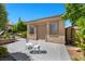 Back structure features a tan exterior, double entry door, adjacent windows, concrete patio, and patio seating at 9270 Valerie Elaine St, Las Vegas, NV 89139