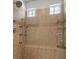 Tiled shower with a built-in bench, rainfall showerhead, and glass door at 9270 Valerie Elaine St, Las Vegas, NV 89139