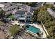 Aerial view of property with pool, spa, covered patio and lush landscaping at 9301 Queen Charlotte Dr, Las Vegas, NV 89145