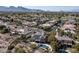 Expansive aerial view showcases a luxurious home with a private pool and solar panels in a well-maintained neighborhood at 9301 Queen Charlotte Dr, Las Vegas, NV 89145