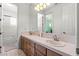 Bathroom with double sink vanity, large mirror and tile flooring at 9301 Queen Charlotte Dr, Las Vegas, NV 89145