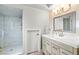 Well-lit bathroom boasts a modern vanity, stylish mirror, and walk-in shower at 9301 Queen Charlotte Dr, Las Vegas, NV 89145