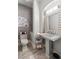 Stylish powder room featuring gray walls, pedestal sink and modern fixtures at 9301 Queen Charlotte Dr, Las Vegas, NV 89145