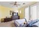 Bright bedroom features a ceiling fan, carpeted floors, and desk area at 9301 Queen Charlotte Dr, Las Vegas, NV 89145