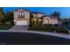 Stunning two-story home boasting a well-manicured lawn and three-car garage, all enveloped in lush landscaping at 9301 Queen Charlotte Dr, Las Vegas, NV 89145
