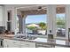 Kitchen featuring stone countertops, stainless appliances, and a view of the outdoor pool at 9301 Queen Charlotte Dr, Las Vegas, NV 89145