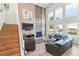 Open concept living room with fireplace, stairway, and backyard view at 9301 Queen Charlotte Dr, Las Vegas, NV 89145