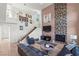 Open concept living room with fireplace, stairway, and view of the loft area at 9301 Queen Charlotte Dr, Las Vegas, NV 89145