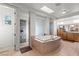 Bright main bathroom with large tub, natural light, and shower at 9301 Queen Charlotte Dr, Las Vegas, NV 89145