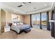 Comfortable main bedroom with carpet, natural light, and balcony access at 9301 Queen Charlotte Dr, Las Vegas, NV 89145