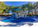 Colorful playground with various play structures and soft, blue flooring at 9301 Queen Charlotte Dr, Las Vegas, NV 89145