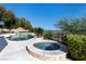 Resort style pool and spa surrounded by lush landscaping and mature trees at 9301 Queen Charlotte Dr, Las Vegas, NV 89145