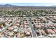 Expansive aerial view of a residential neighborhood with tree-lined streets and well-maintained homes near majestic mountains at , Henderson, NV 89074