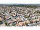 An aerial view of a neighborhood in a desert environment featuring many homes and roads at , Henderson, NV 89074