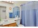 Bathroom featuring a blue shower curtain, toilet, sink, mirror, and wood vanity at , Henderson, NV 89074