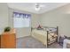 Bright bedroom with carpet, fan, window and blinds, light walls, bed, dresser, and decor at , Henderson, NV 89074