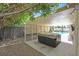 Backyard with a covered patio featuring a hot tub, creating a luxurious and private outdoor oasis, surrounded by lush greenery at , Henderson, NV 89074