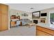 Open-concept living space with a fireplace, desk area, and access to the outdoors at , Henderson, NV 89074