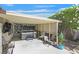 Covered outdoor patio featuring a jacuzzi, TV, and ample seating, perfect for entertaining guests in comfort at , Henderson, NV 89074