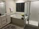 Bright bathroom featuring a soaking tub with separate glass door shower enclosure at 10148 Cluny Ave, Las Vegas, NV 89178