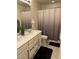 Bathroom with double sink vanity and shower with decorative shower curtain at 10148 Cluny Ave, Las Vegas, NV 89178