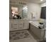 Bright bathroom features a soaking tub with separate glass door shower enclosure and double sinks at 10148 Cluny Ave, Las Vegas, NV 89178