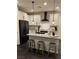 Modern kitchen with white cabinets, stainless steel appliances, granite countertops, and a breakfast bar at 10148 Cluny Ave, Las Vegas, NV 89178