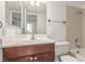 Bright bathroom featuring a vanity with ample storage, a mirror and a shower/tub combo at 1017 Falconhead Ln # 101, Las Vegas, NV 89128